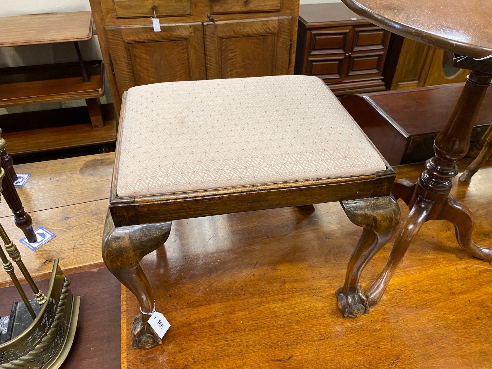 A George III style beech dressing stool on ball and claw feet, width 55cm, height 47cm.